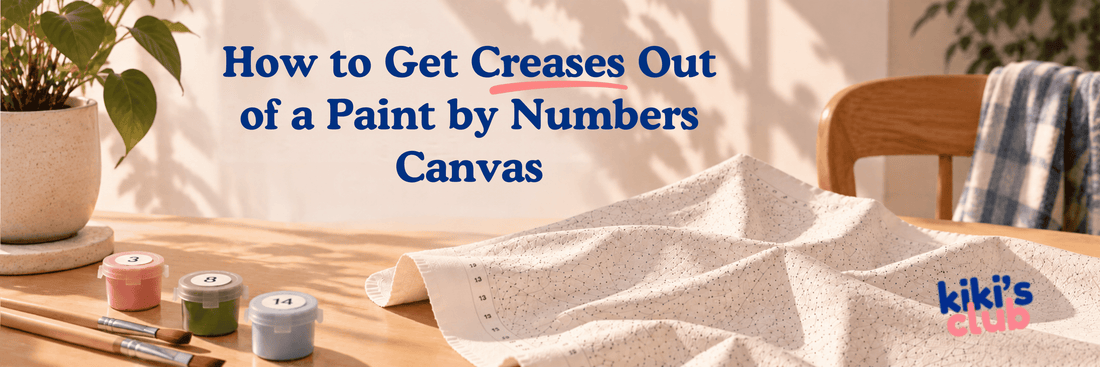 Creased paint by numbers canvas on a table with paint pots and brushes, illustrating how to flatten wrinkles before painting.