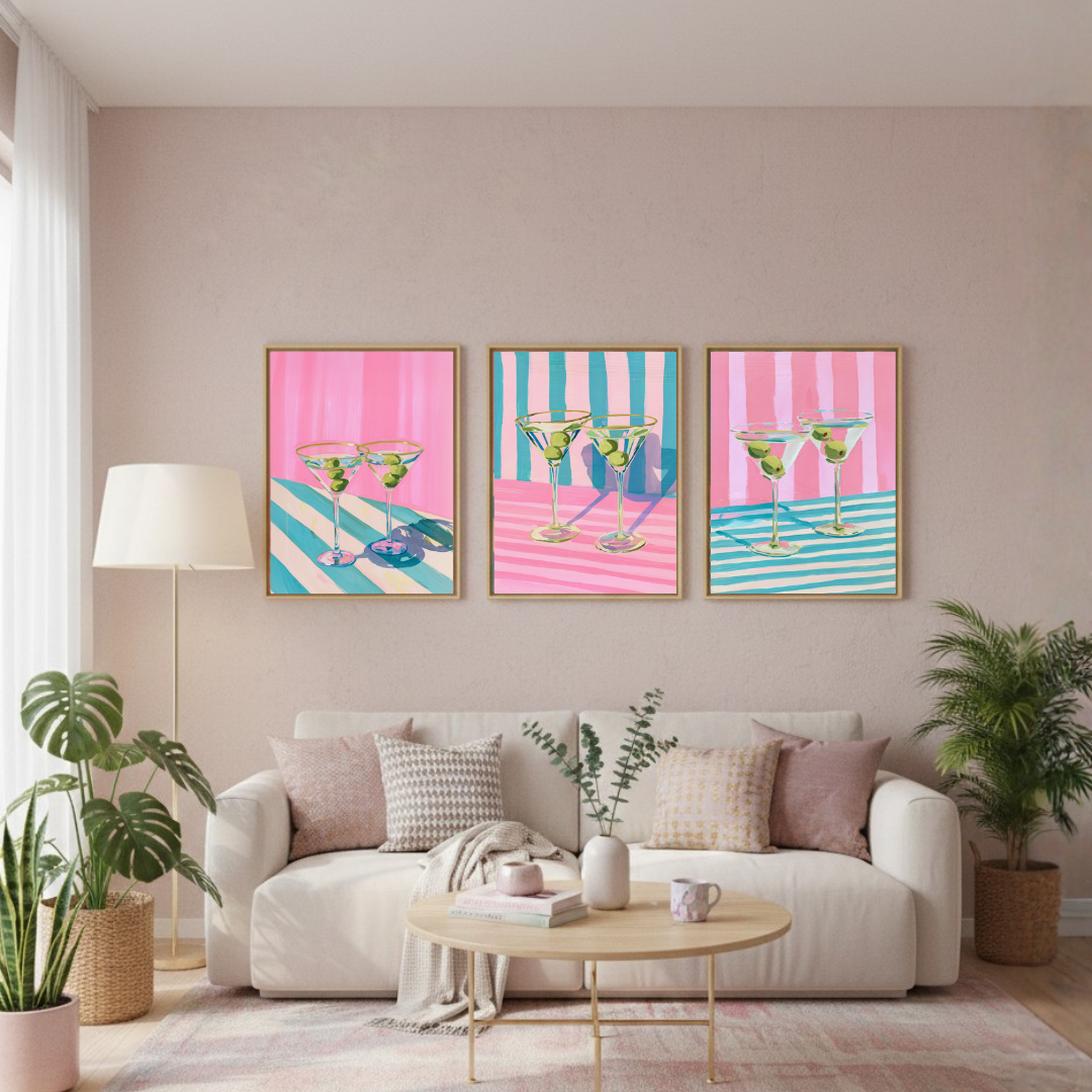 Living room with a white sofa, coffee table, and three colorful wall art prints of martini glasses.